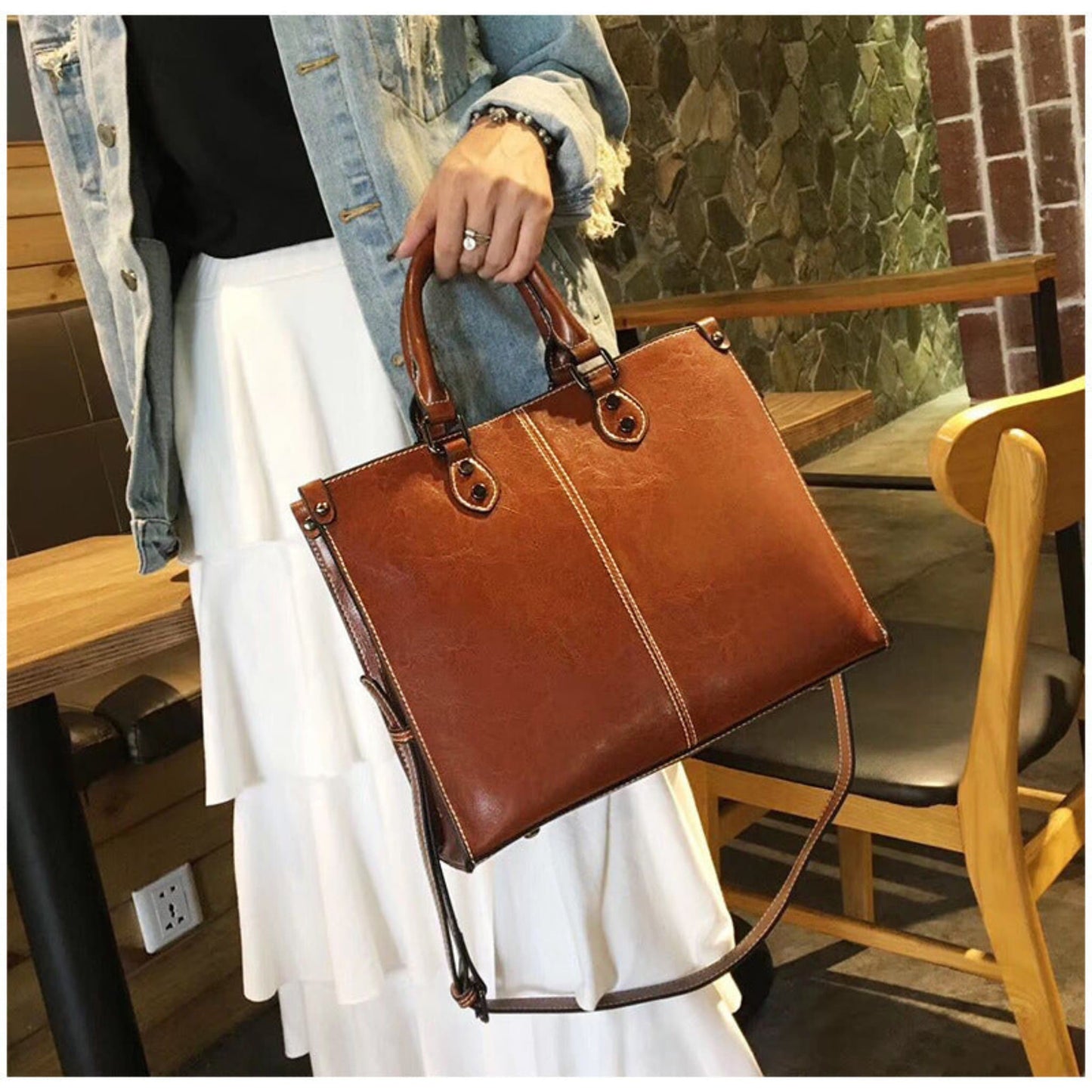 Woman Carrying Women's Genuine Cowhide Leather Crossbody Handbag in Brown by Top Handle – Avenue