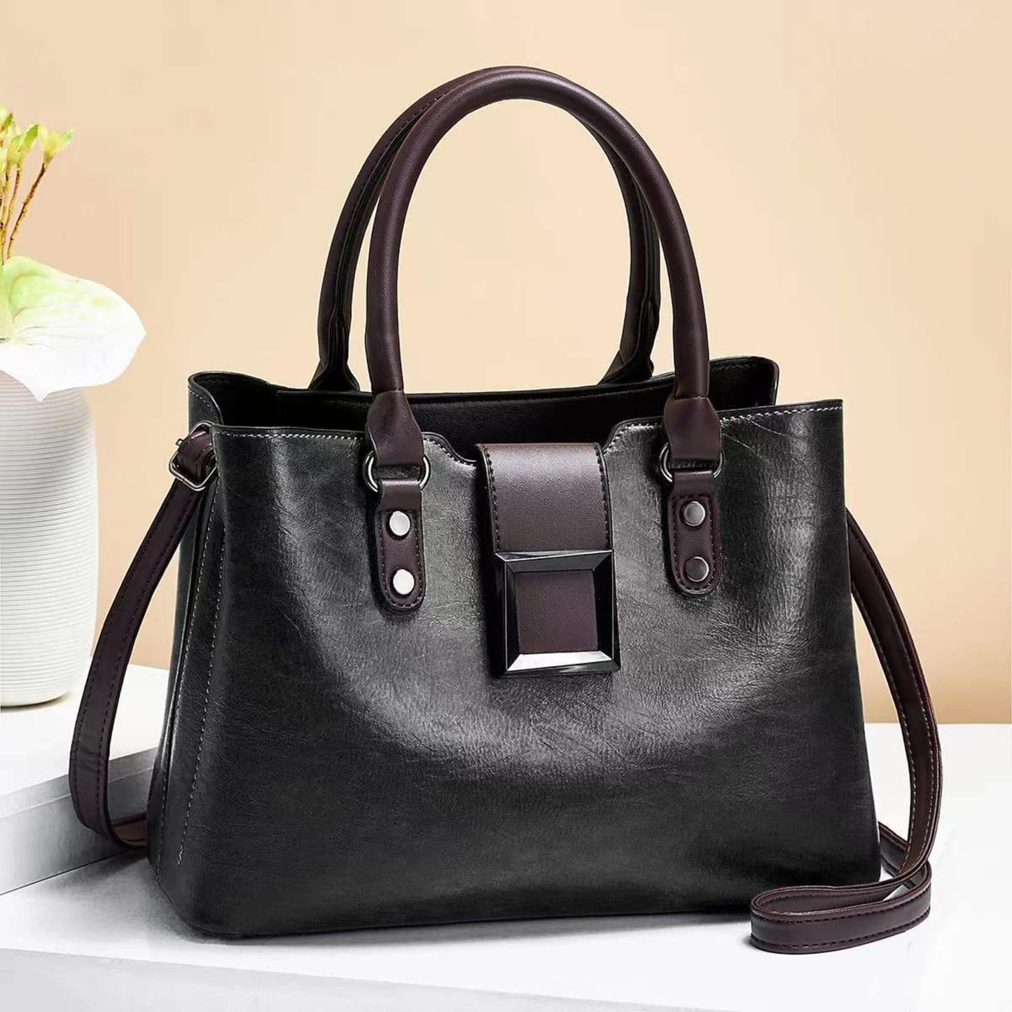 woMen's lychee pattern structured PU leather handbag in Black with brown accents on light background | Avenue