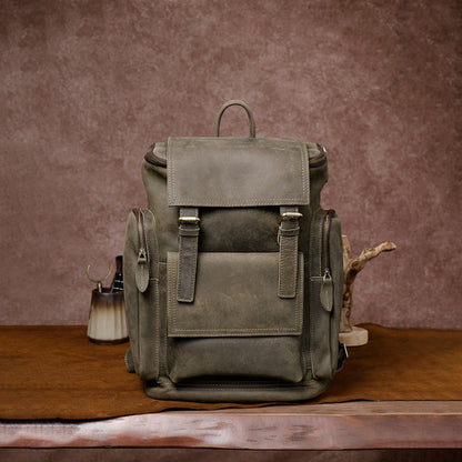 Retro crazy horse leather Men's laptop backpack large capacity in army green on wooden surface and brown background – front view | Avenue