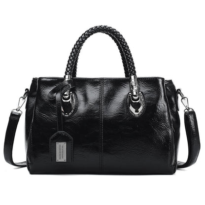 Women's vintage oil wax PU handbag in Black with braided handle on white background front view | Avenue