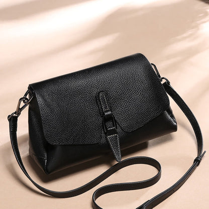 woMen's soft leather shoulder messenger bag in black on beige background showing adjustable strap position | Avenue
