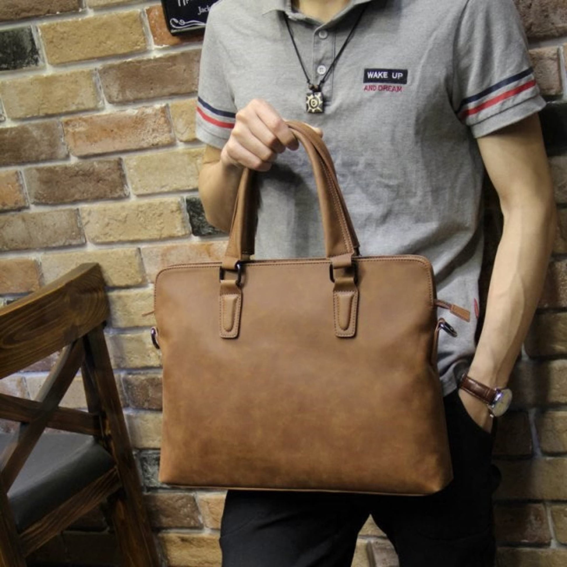 Avenue Crazy Horse Leather Men's Handbag & Laptop Bag – Coffee Vintage Shoulder Bag Carried by Man in Casual Outfit Against Brick Wall

