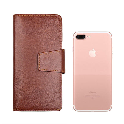 Men's premium RFID protected Maroon long leather wallet standing upright with a mobile phone demonstrating safe phone storage compartment | Avenue