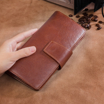 Men's premium RFID protected Maroon hand holding long leather wallet on brown surface lifestyle shot | Avenue