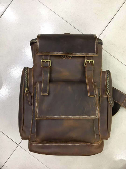 Retro crazy horse leather Men's laptop backpack large capacity in brown on tiled floor – front view | Avenue