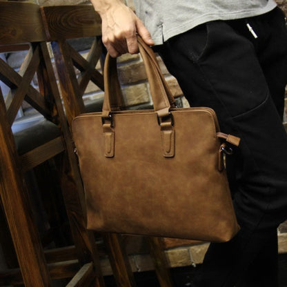 Avenue Crazy Horse Leather Men's Handbag & Laptop Bag – Coffee Vintage Shoulder Bag Held by Man, Front View with Dual Handles
