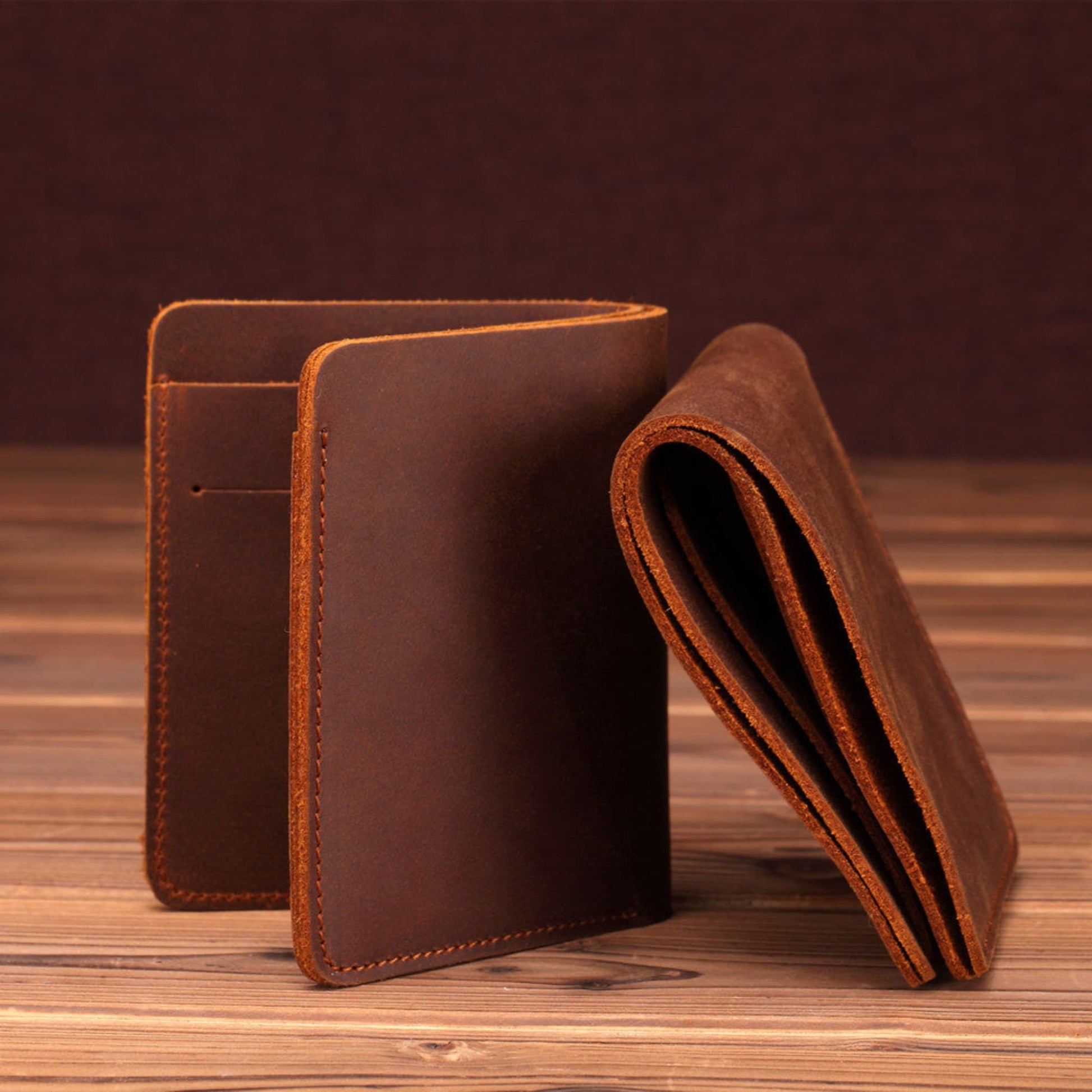 Men's Handmade Crazy Horse Leather Wallet in brown — closed exterior and folded edge view showing hand-stitched detailing on a wooden surface | Avenue