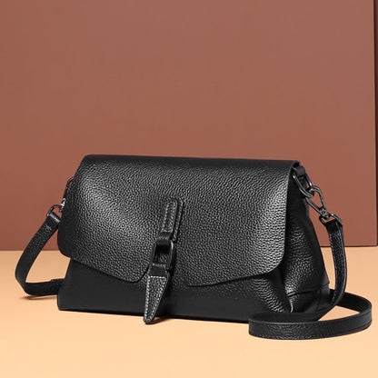 woMen's soft leather shoulder messenger bag in black on brown background showing detachable strap position | Avenue