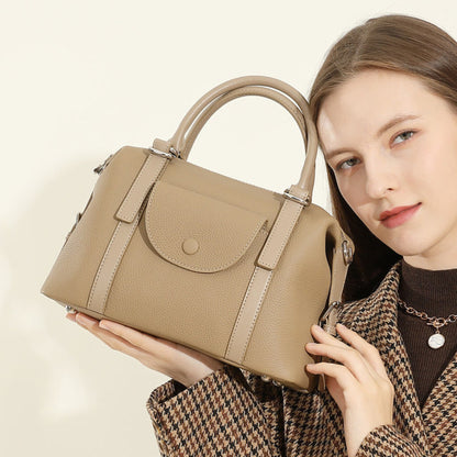 Avenue Elephant Gray Women’s Genuine Leather Shoulder Handbag shown at an angle, with top handles and front flap, held by a model against a light neutral background.