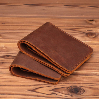 Men's Handmade Crazy Horse Leather Wallet in brown — two wallets stacked closed showing rich natural grain, warm patina, and hand-stitched edges on a wooden surface | Avenue