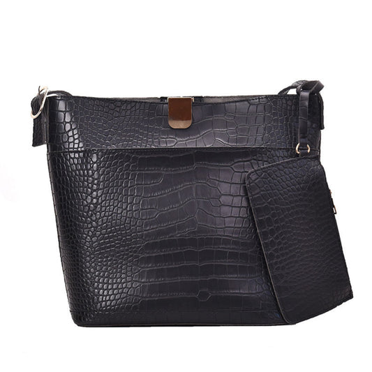 Women's one shoulder bucket bag in black, croc-embossed PU leather with magnetic snap closure, attached mini pouch and gold hardware, white background | Avenue