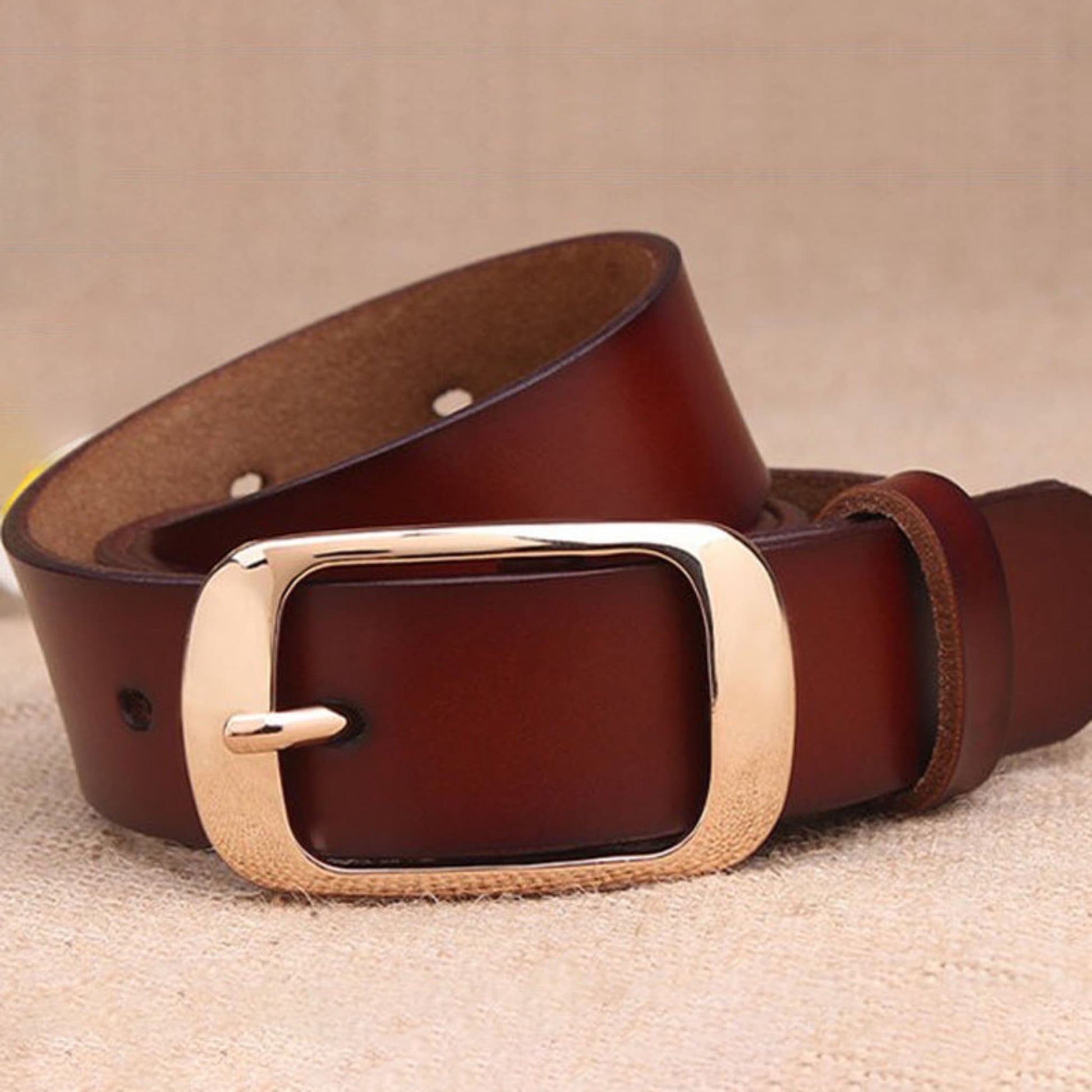 Women's brown leather fashion belt with gold buckle, loose open loop showing adjustment holes –Avenue