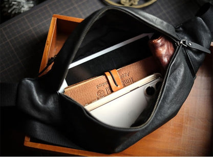 Men's black plant-tanned cow leather crossbody mobile phone bag open interior view showing spacious compartment with notebook, phone and essentials — Avenue