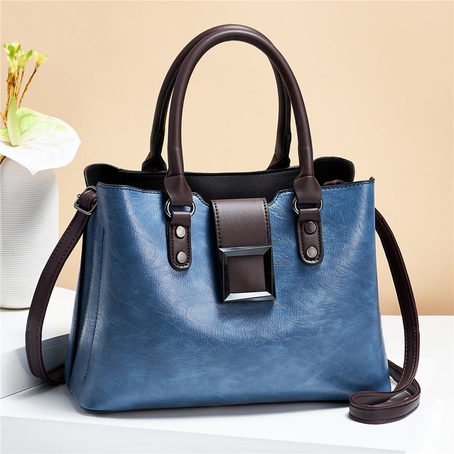 woMen's lychee pattern structured PU leather handbag in Blue with brown accents on light background | Avenue