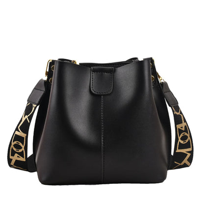 Avenue Wide Shoulder Strap Bucket Bag for Women in Black - PU Leather Crossbody Bag Front View with Adjustable Patterned Shoulder Strap and Gold Hardware