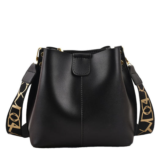 Avenue Wide Shoulder Strap Bucket Bag for Women in Black - PU Leather Crossbody Bag Front View with Adjustable Patterned Shoulder Strap and Gold Hardware