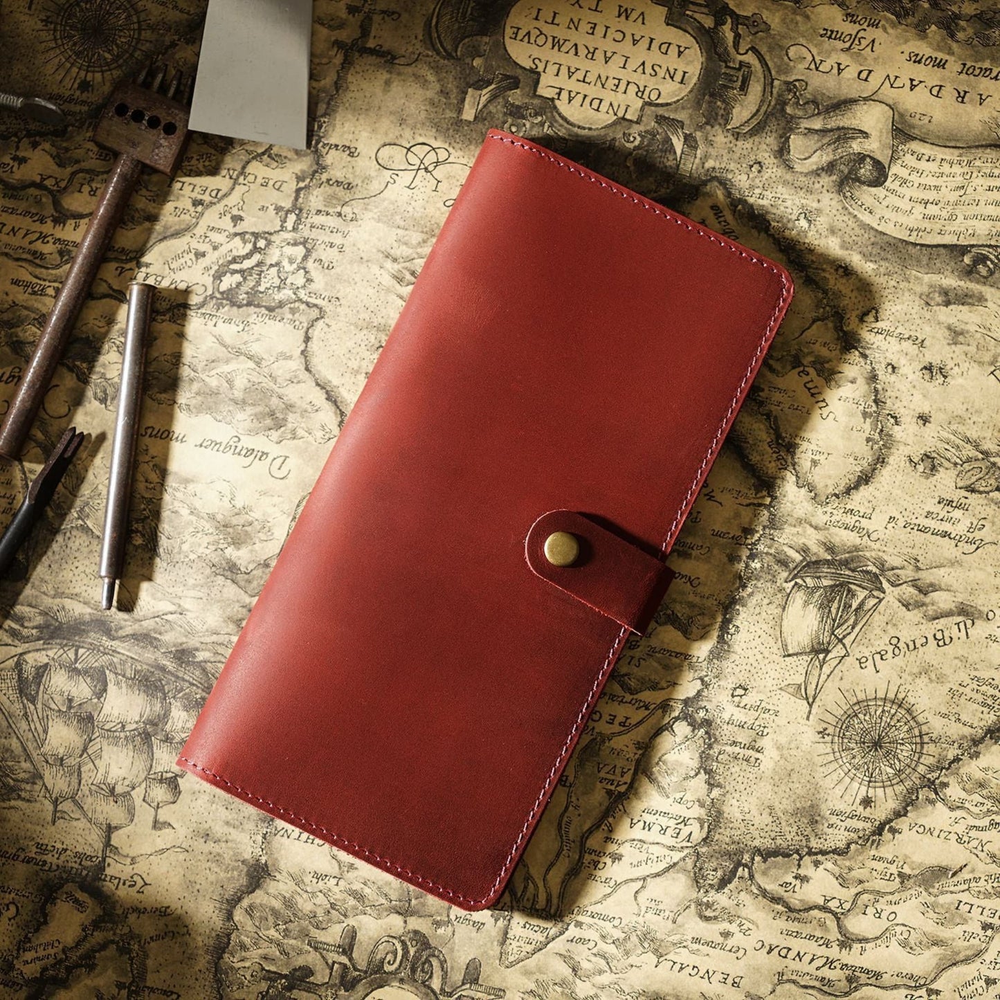 Avenue Retro Crazy Horse Leather Long Wallet in Wine Red – Unisex Genuine Leather Wallet with Brass Snap Closure, styled on a vintage world map with leather crafting tools