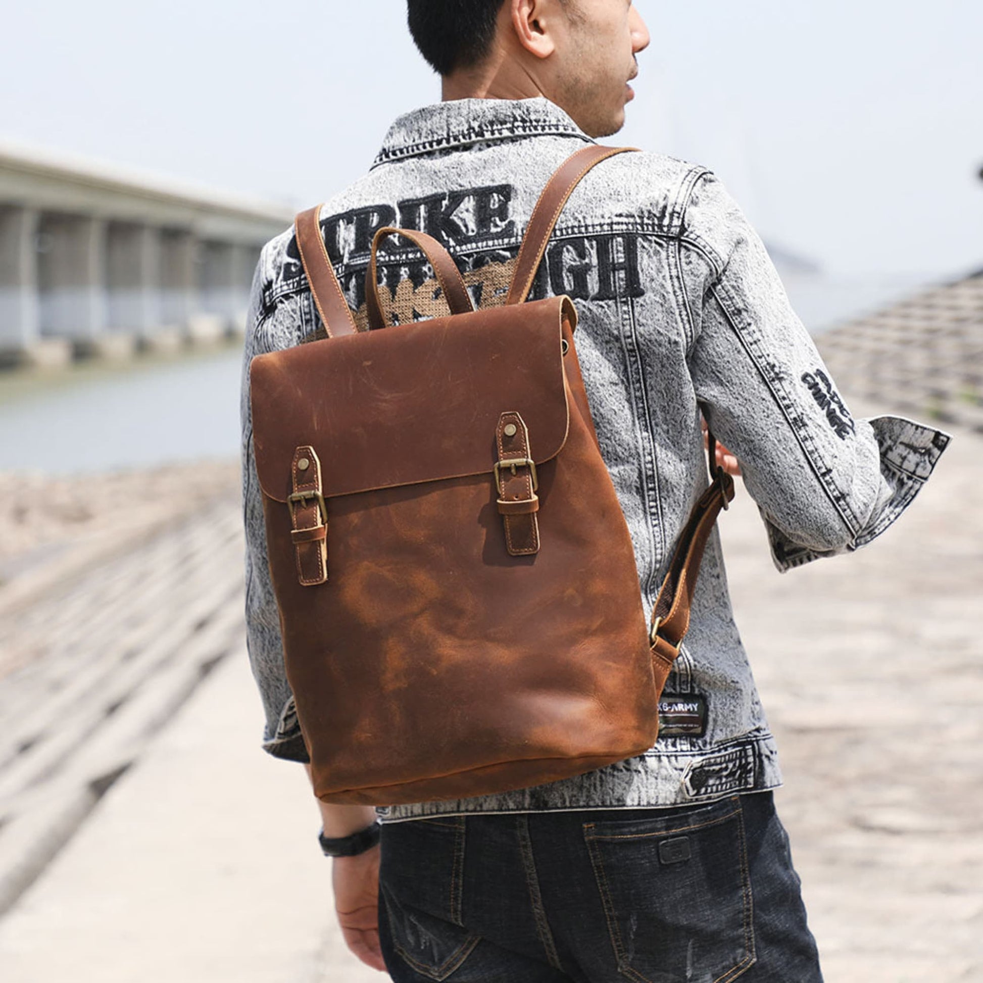 Avenue Retro First Layer Cowhide Leather Backpack – Brown Worn on Back by Man at Outdoor Waterfront