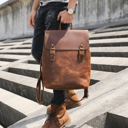 Avenue Retro First Layer Cowhide Leather Backpack – Brown Lifestyle Shot Held by Man on Outdoor Steps
