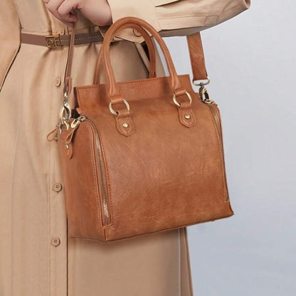 Model wearing ladies glossy vintage tote bag  on shoulder, lifestyle view on light background | Avenue