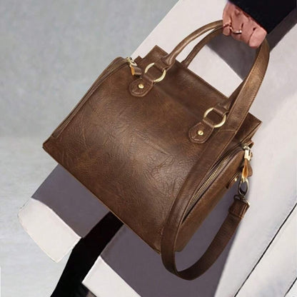 Model holding ladies glossy vintage tote bag lifestyle view on light background | Avenue