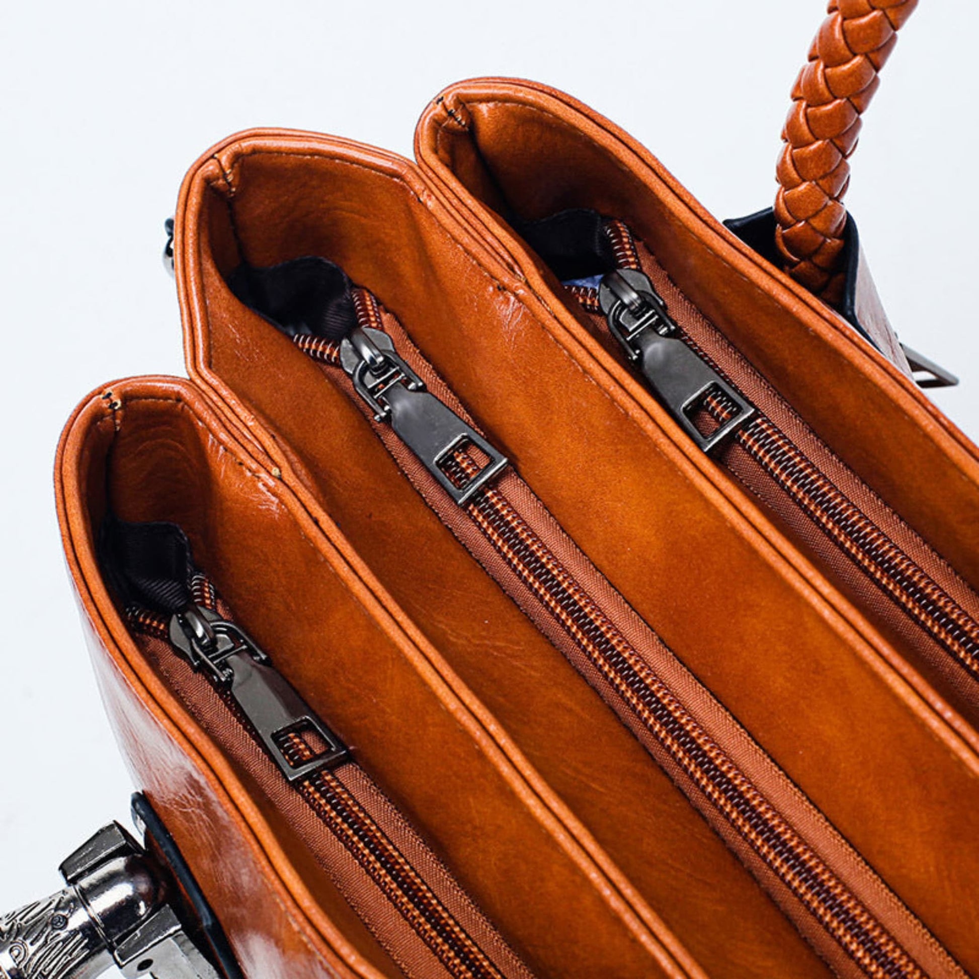 Women's vintage oil wax PU handbag in Brown, compartments zipper close-up view on Grey background | Avenue