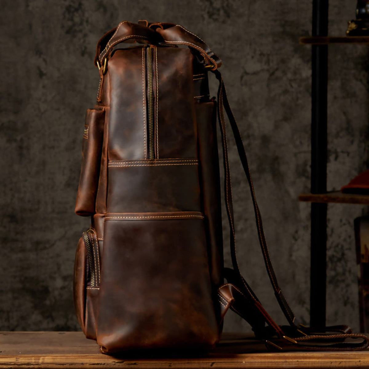 Unisex handmade retro crazy horse leather oversized backpack in brown, side profile view showing depth, contrast stitching and adjustable shoulder straps | Avenue