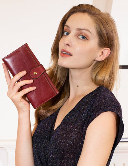 RFID Protected Women's Leather Wallet in Red held by Model – Lifestyle View | Avenue
