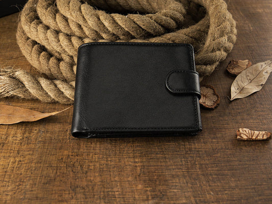 Avenue Men's Short Leather Wallet – Genuine Cowhide in Black, front view with snap closure, displayed on rustic rope and wooden surface