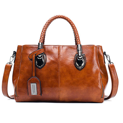 Women's vintage oil wax PU handbag in Brown with braided handle on white background front view | Avenue