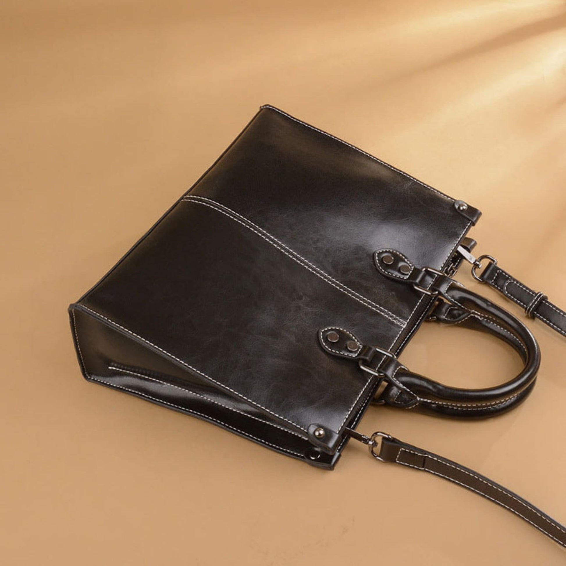 Women's Genuine Cowhide Leather Crossbody Handbag in Black – Side View Showing Stitching Detail and Hardware – Avenue