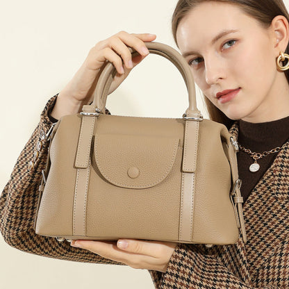 Avenue Elephant Gray Women’s Genuine Leather Shoulder Handbag with top handles and front flap, held close to a model against a light neutral background.