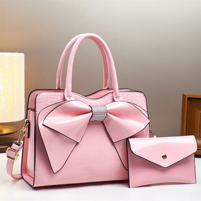 pink patent leather bow bucket bag and matching wallet | Avenue