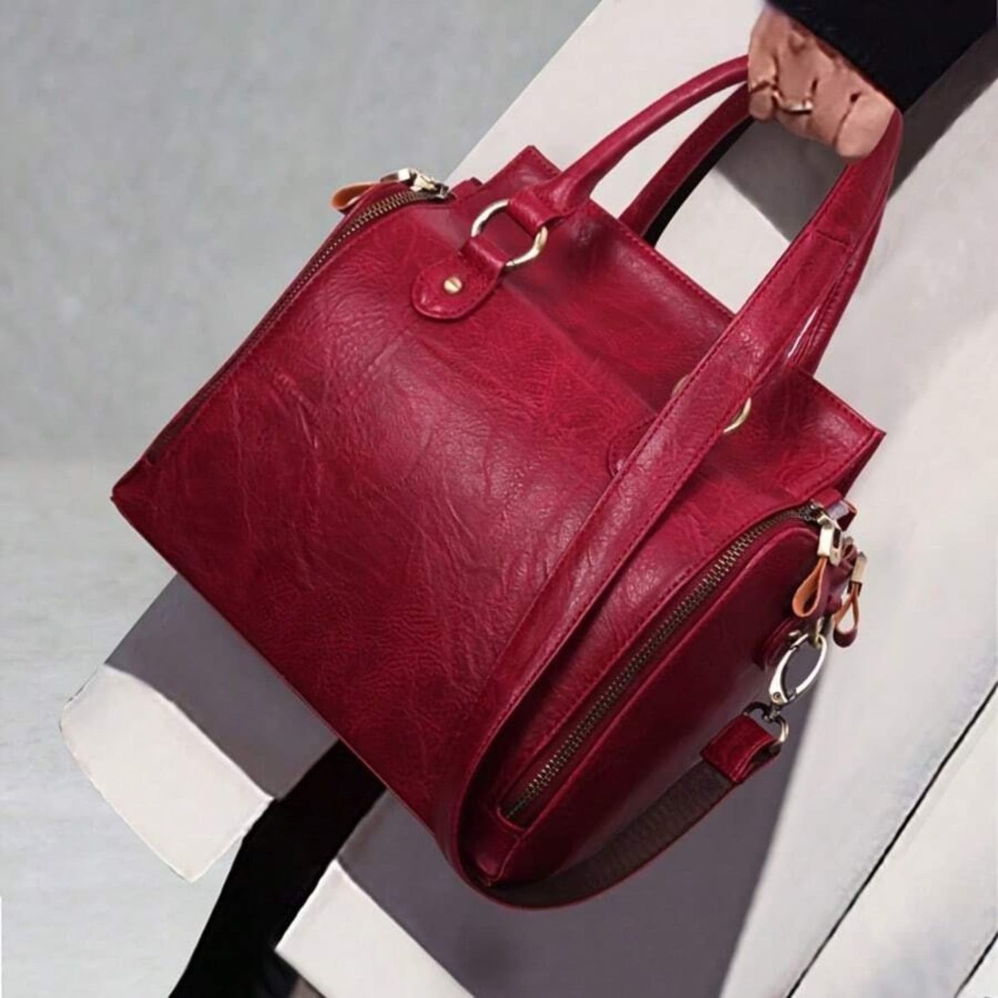 Model holding ladies glossy vintage tote bag lifestyle view on light background | Avenue