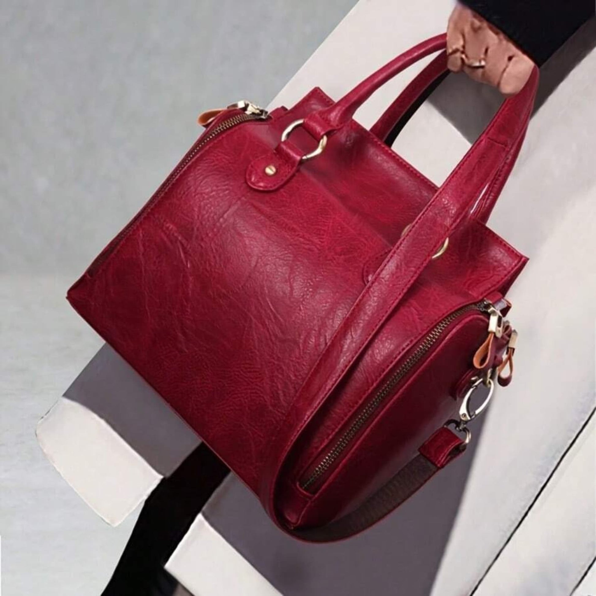Model holding ladies glossy vintage tote bag lifestyle view on light background | Avenue