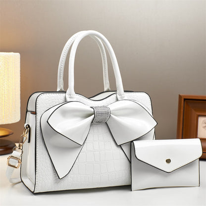 white patent leather bow bucket bag and matching wallet | Avenue