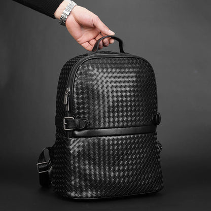 Man holding black braided leather backpack by top handle – lifestyle shot showcasing premium woven texture and zipper detail | Avenue
