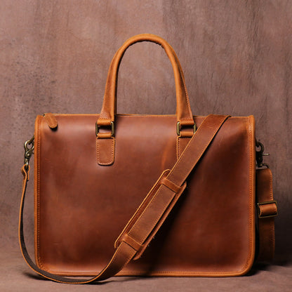 Men's Crazy Horse Leather Briefcase | Vintage Laptop Bag – Vintage Brown Front View with Top Handles, Antique Brass Hooks and Shoulder Strap on Vintage Brown Textured Background by Avenue