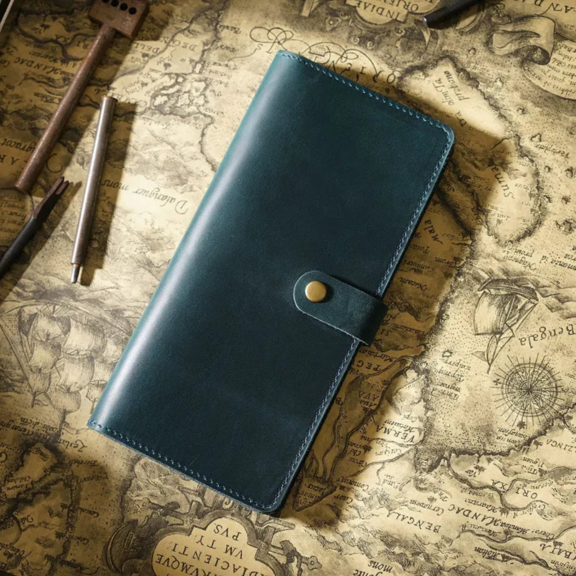 Avenue Retro Crazy Horse Leather Long Wallet in Blue – Unisex Genuine Leather Wallet with Brass Snap Closure, styled on a vintage world map with leather crafting tools