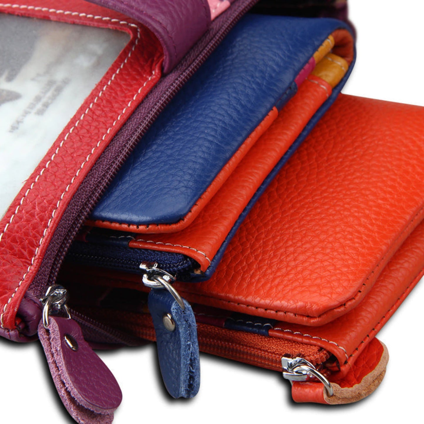 Women's RFID blocking genuine cowhide long leather wallets in three colours stacked on a white background | Avenue