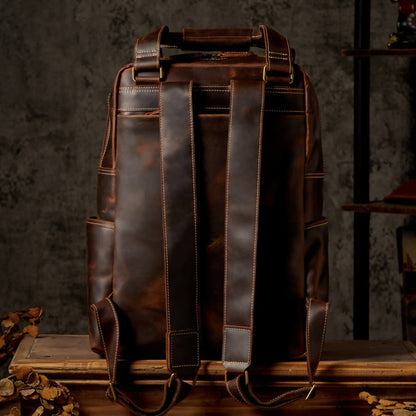 Unisex handmade retro crazy horse leather oversized backpack in brown, rear view showing double padded shoulder straps, antique brass hardware and contrast stitching | Avenue