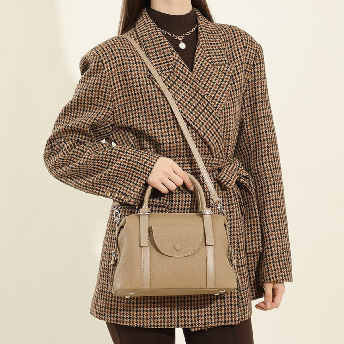 Avenue Elephant Gray Women’s Genuine Leather Shoulder Handbag held by its top handles, with the strap worn across the model’s torso against a light neutral background.