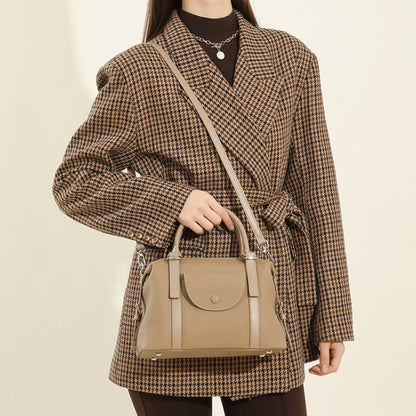 Avenue Elephant Gray Women’s Genuine Leather Shoulder Handbag held by its top handles, with the strap worn across the model’s torso against a light neutral background.