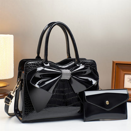 black patent leather bow bucket bag and matching wallet | Avenue