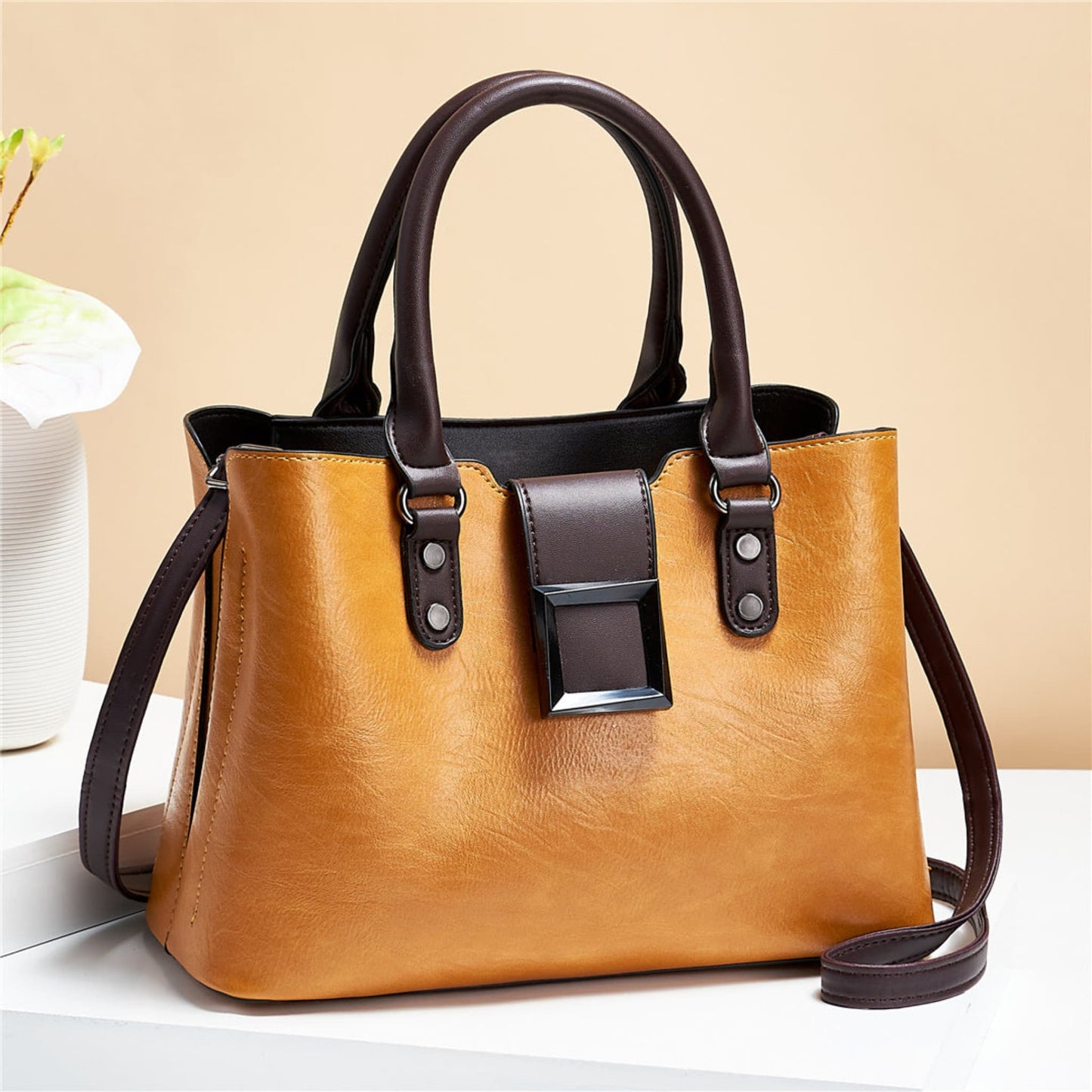 woMen's lychee pattern structured PU leather handbag in Turmeric with brown accents on light background | Avenue