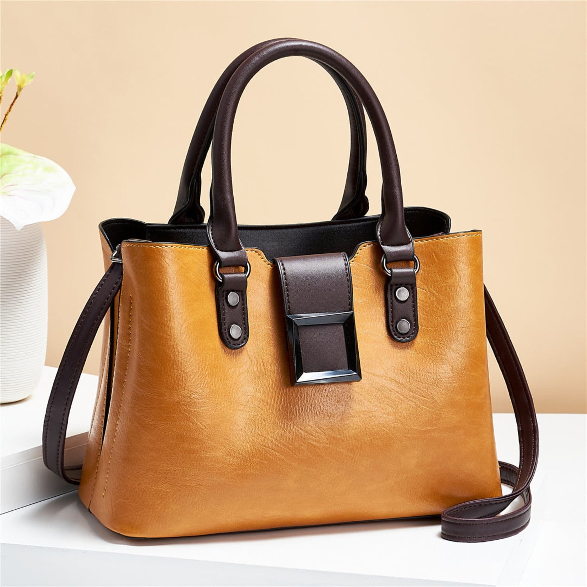 woMen's lychee pattern structured PU leather handbag in Turmeric with brown accents on light background | Avenue