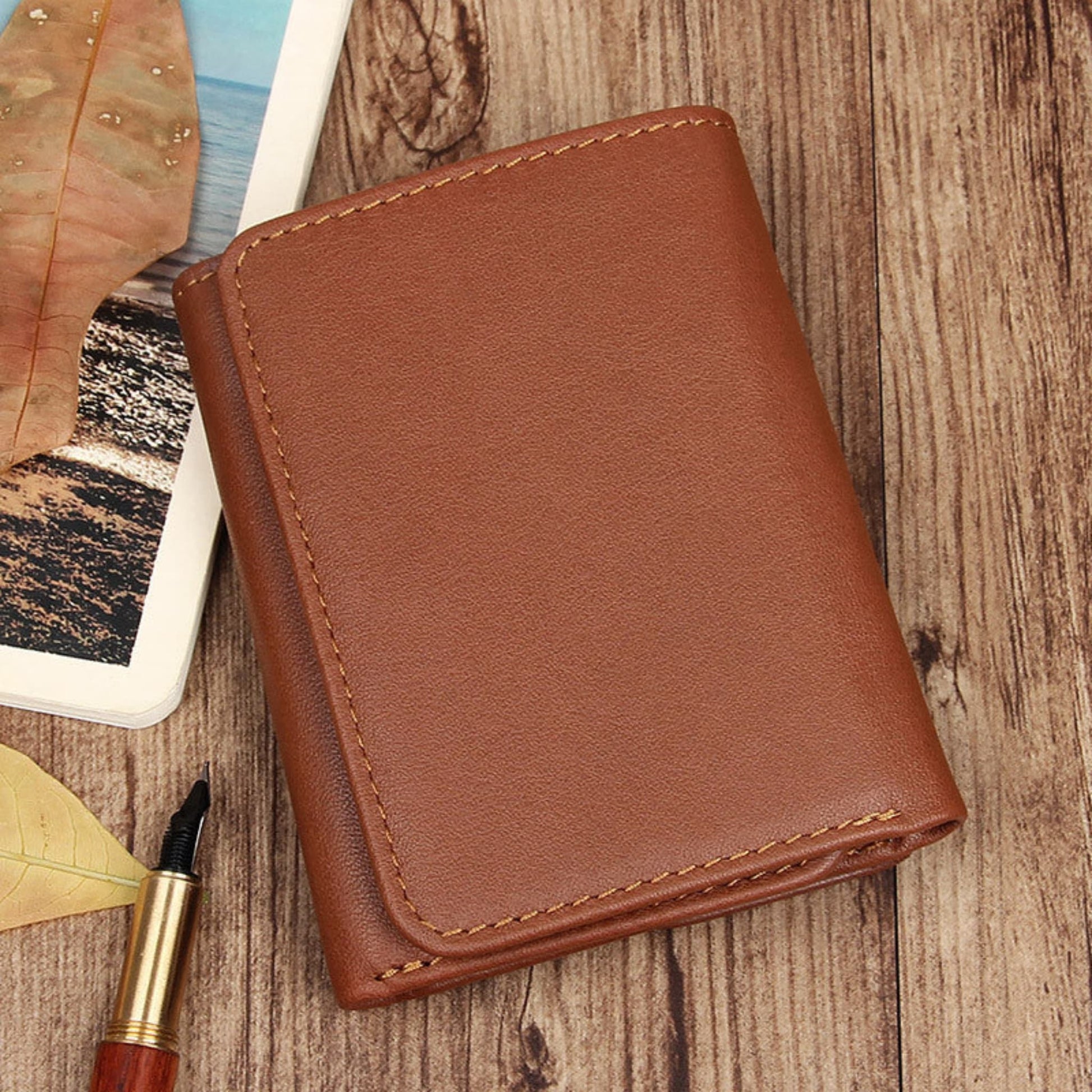Avenue Men's RFID Blocking Leather Wallet – Retro Anti-Scanning Bifold in Brownish Yellow, front view on wooden surface